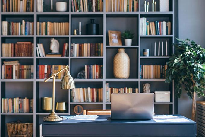 Custom blue office with build in book case in the background