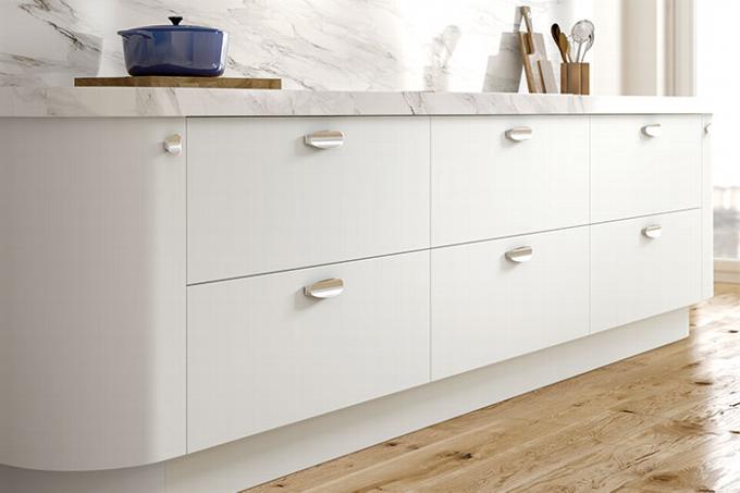 flat white drawers in kitchen with chrome wave handles