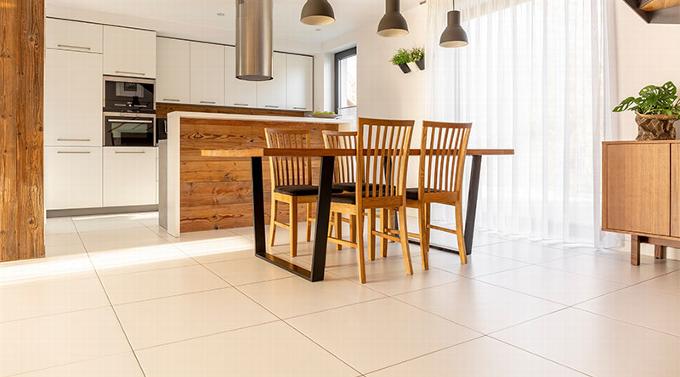 white and wood kitchen with plain white tile floor