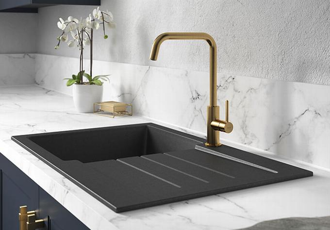 Brushed brass kitchen tap and black sink