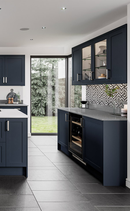 A blue fitted kitchen with a large window